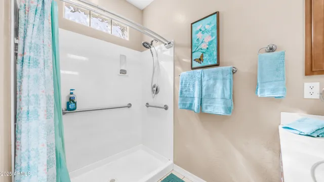 a bathroom with a shower and a mirror