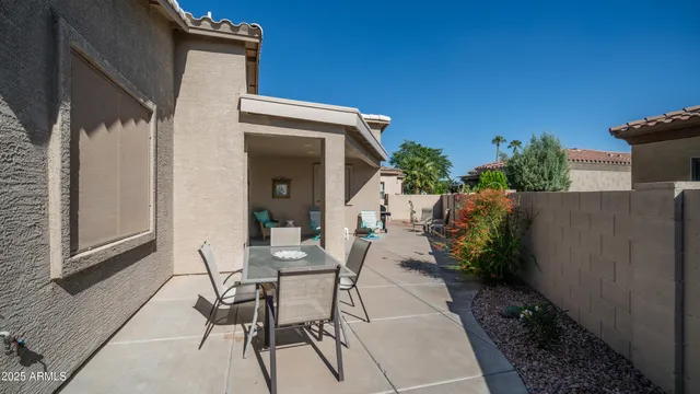 a view of a house with backyard and sitting area