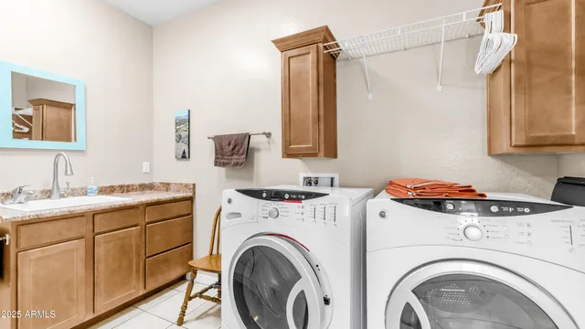 a utility room with dryer washer and a sink