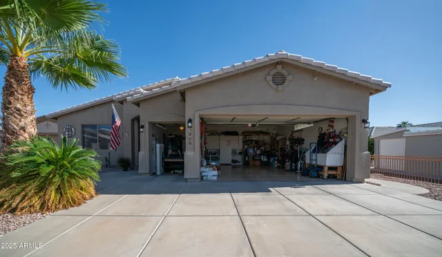 a view of a chairs and table in front of house