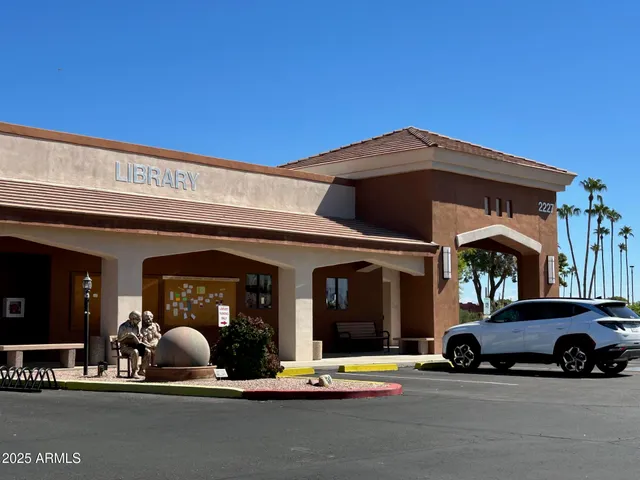 a view of a building with car parked