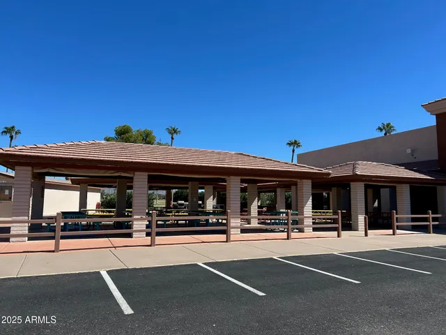 a view of a patio with a table and chairs under an umbrella