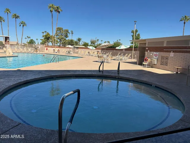 a view of a house with swimming pool patio and fire pit