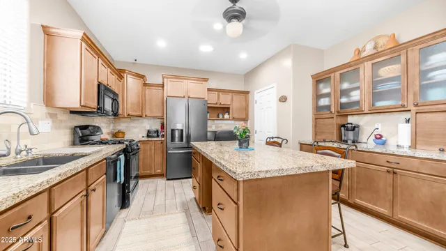 a kitchen with a sink stove and cabinets