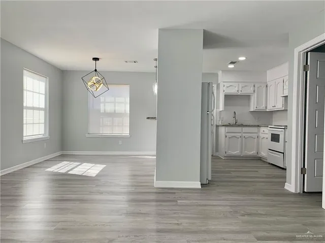 a view of kitchen with wooden floor and window