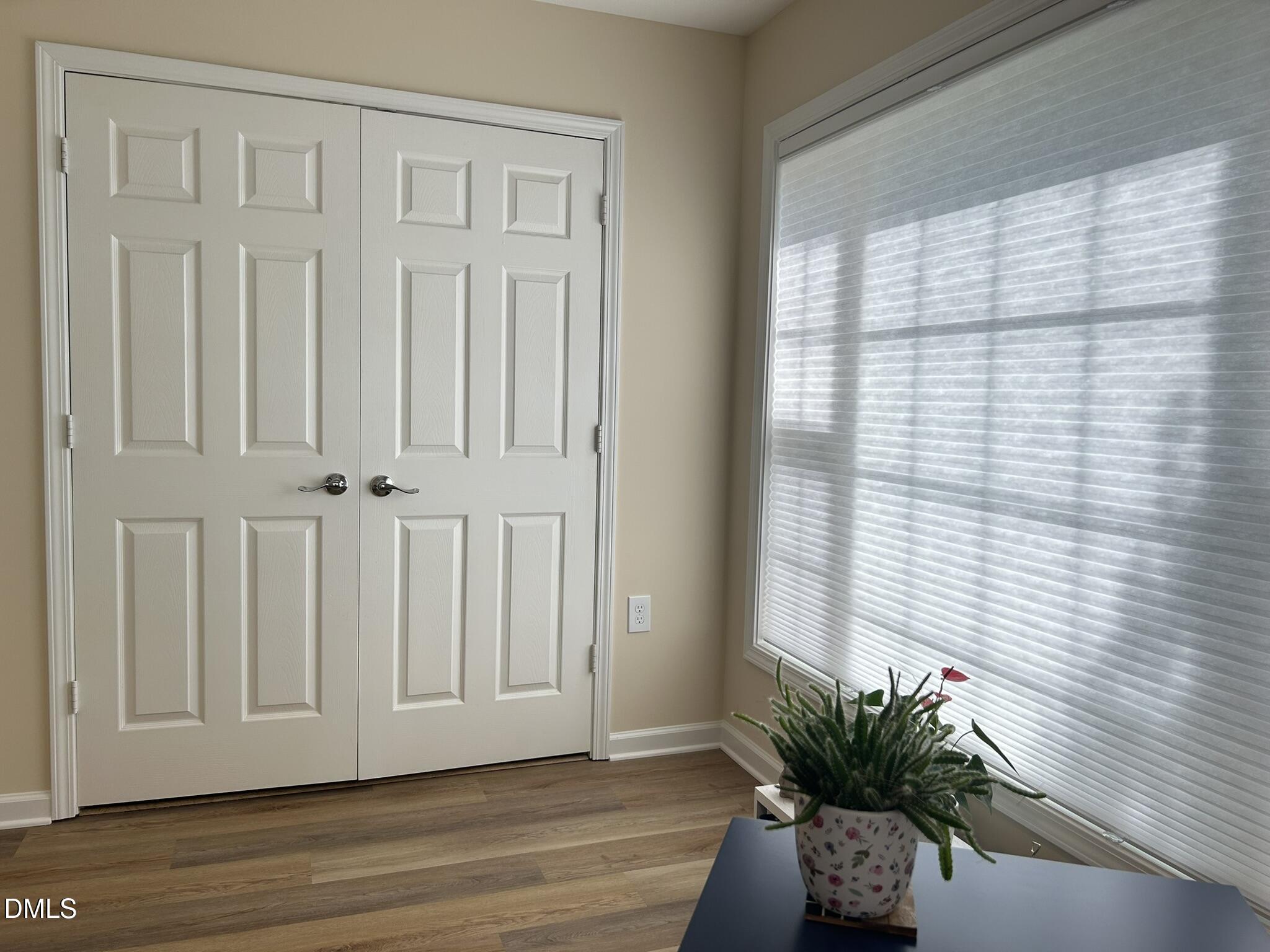 2510 Friedland Place, Unit 102 Raleigh, NC 27617 - Photo 25 of 42 an empty room with wooden floor and windows