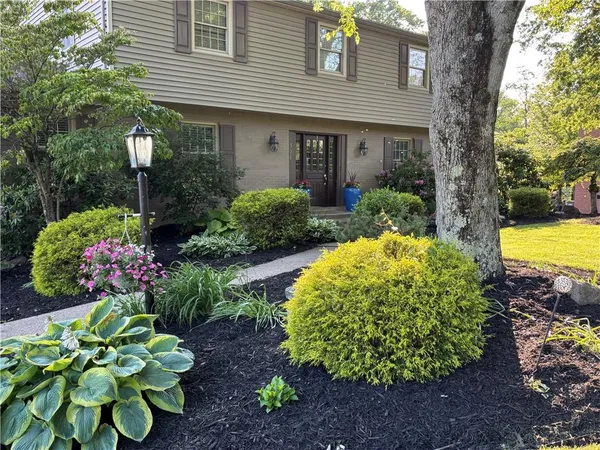 a view of a house with a yard and garden