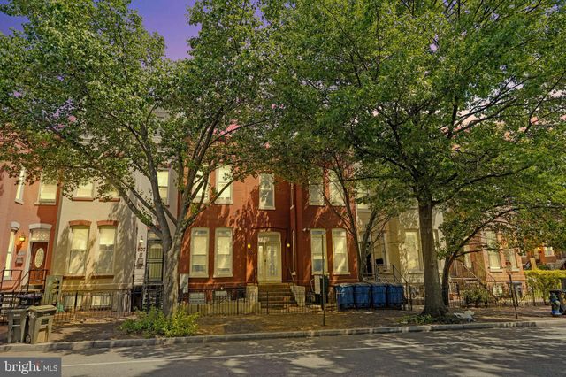 a view of a hallway with wooden floor and entryway