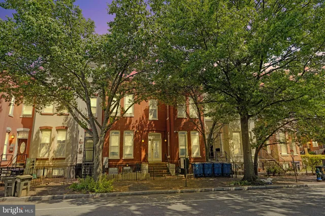 a view of a hallway with wooden floor and entryway