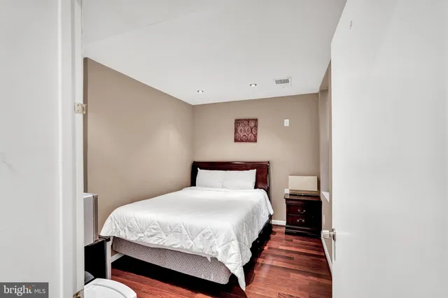 a bed room with a bed and a night stand