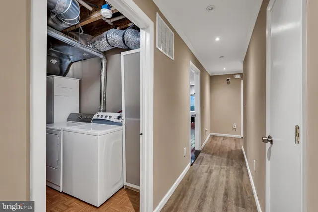 a bedroom with a bed and painting on the wall