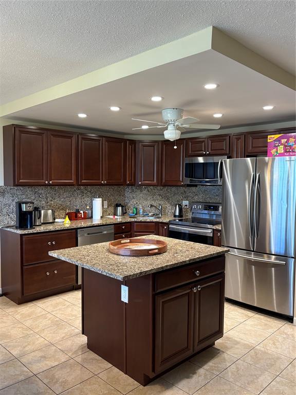 2455 Northeast 51st Street, Unit 207 Fort Lauderdale, FL 33308 - Photo 1 of 6 a kitchen with stainless steel appliances granite countertop a sink a stove a refrigerator and a microwave