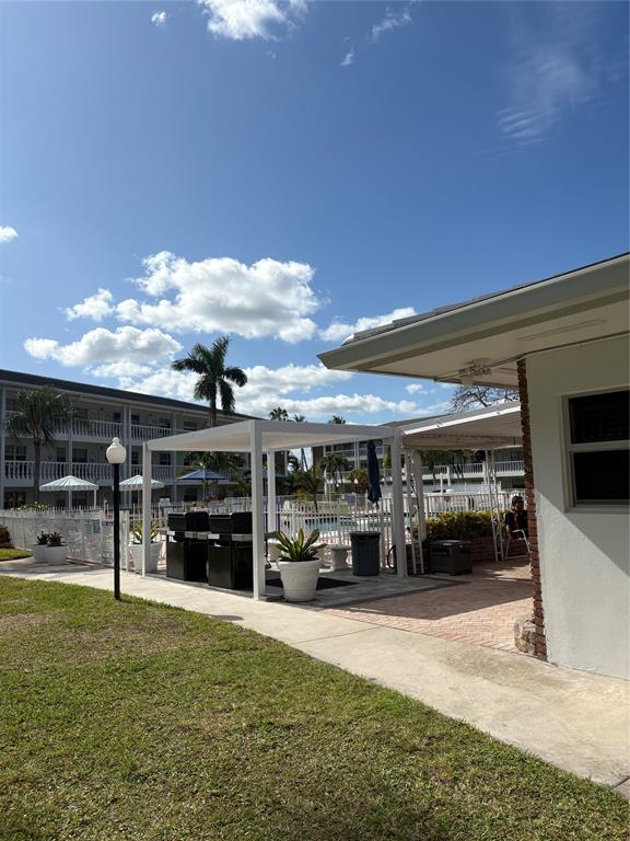 2455 Northeast 51st Street, Unit 207 Fort Lauderdale, FL 33308 - Photo 4 of 6 a living room with furniture and a flat screen tv
