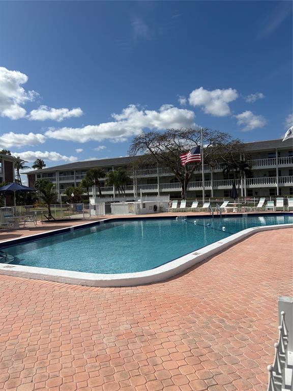 2455 Northeast 51st Street, Unit 207 Fort Lauderdale, FL 33308 - Photo 5 of 6 a view of a swimming pool is middle in the middle of a lake