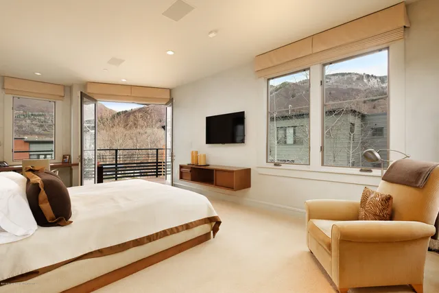 a bedroom with furniture and large window