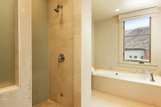 a bathroom with a bathtub and a shower
