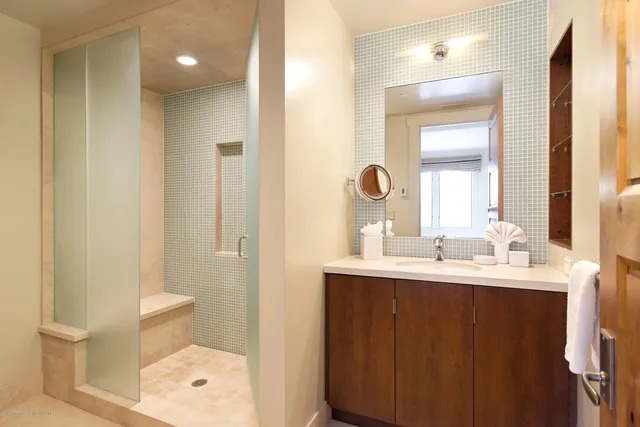 a bathroom with a double vanity sink toilet and a mirror