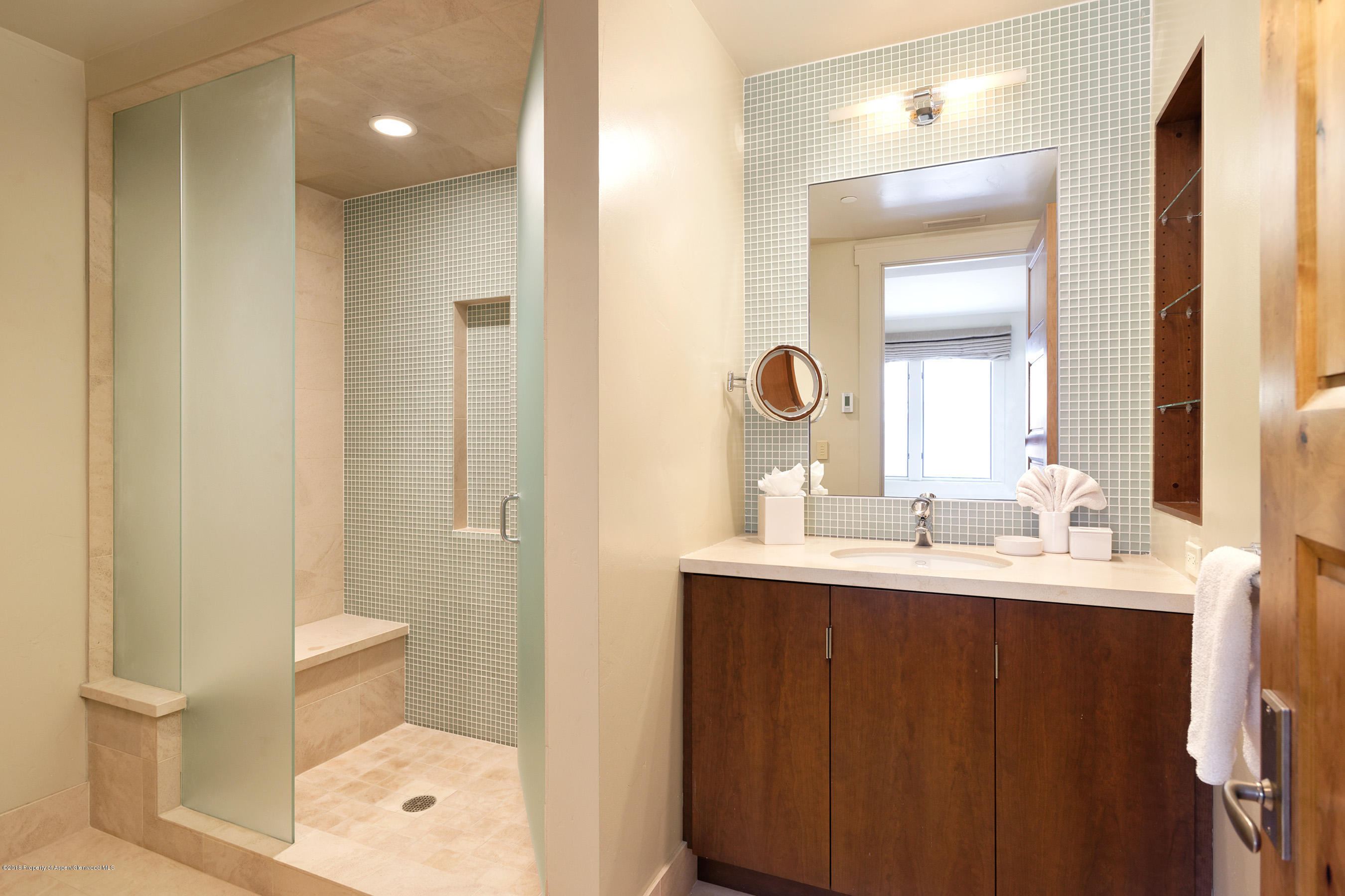 102 Founders Place, Unit 301 Aspen, CO 81611 - Photo 16 of 28 a bathroom with a double vanity sink toilet and a mirror