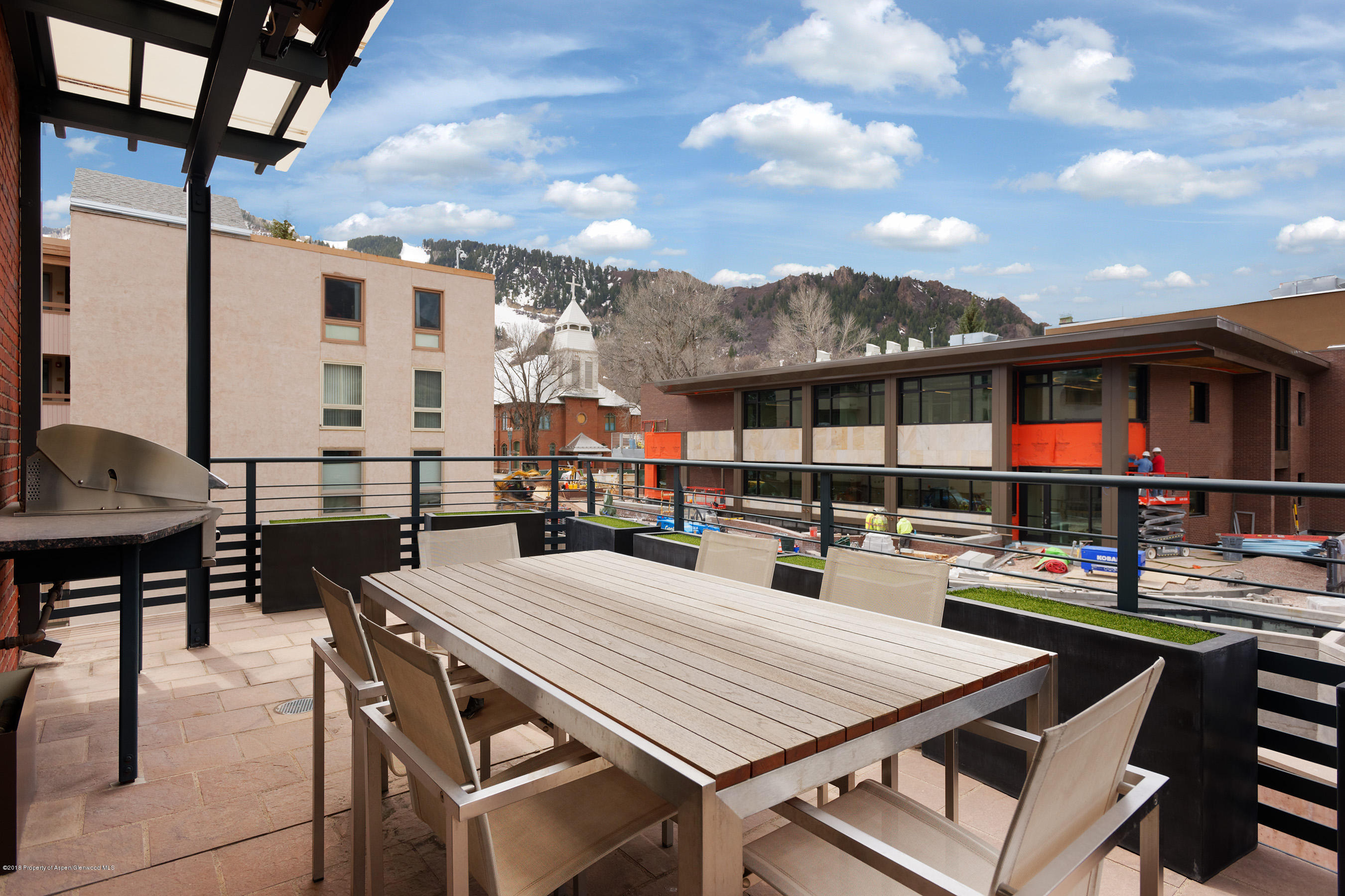 102 Founders Place, Unit 301 Aspen, CO 81611 - Photo 19 of 28 a view of a patio with dining table and chairs