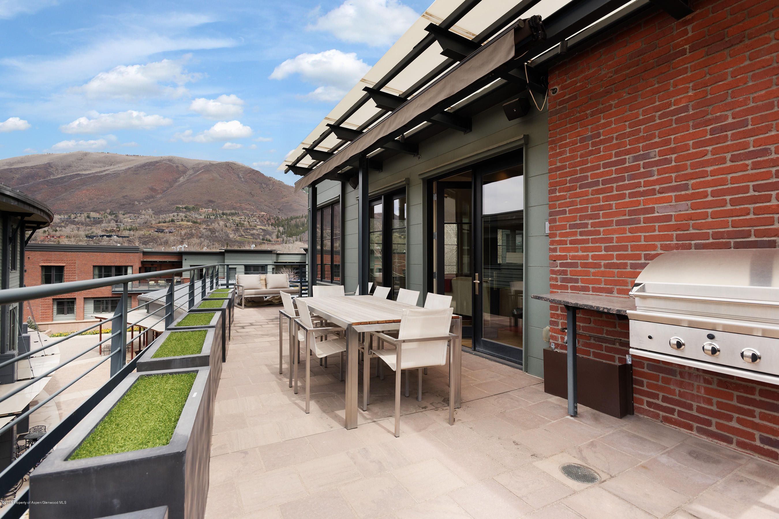 102 Founders Place, Unit 301 Aspen, CO 81611 - Photo 20 of 28 a view of a patio with a table and chairs