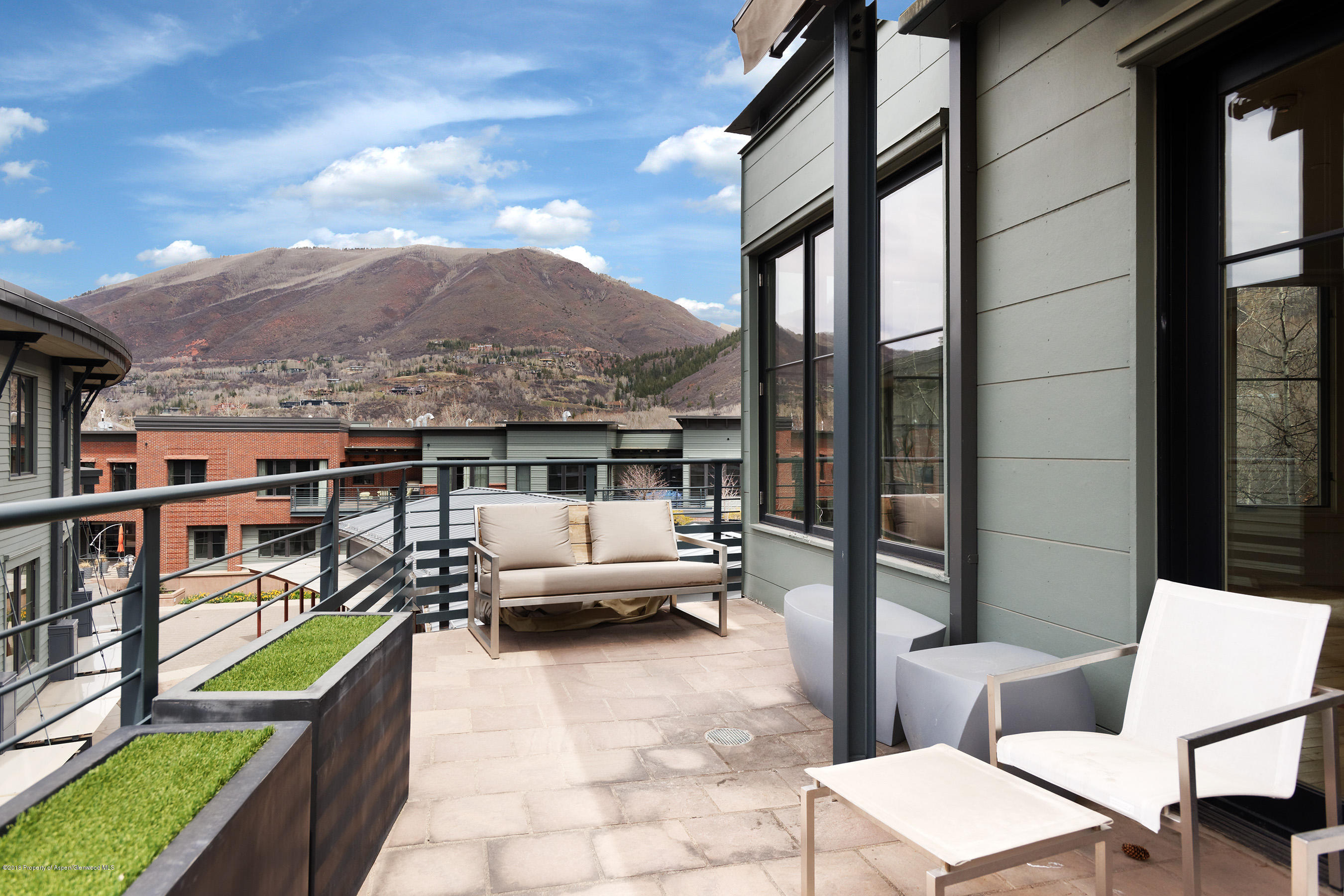 102 Founders Place, Unit 301 Aspen, CO 81611 - Photo 21 of 28 a balcony with furniture and a potted plant