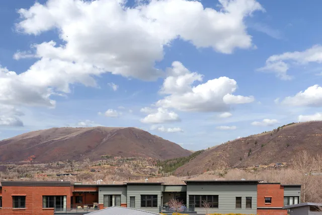 a view of a town with mountains front of house