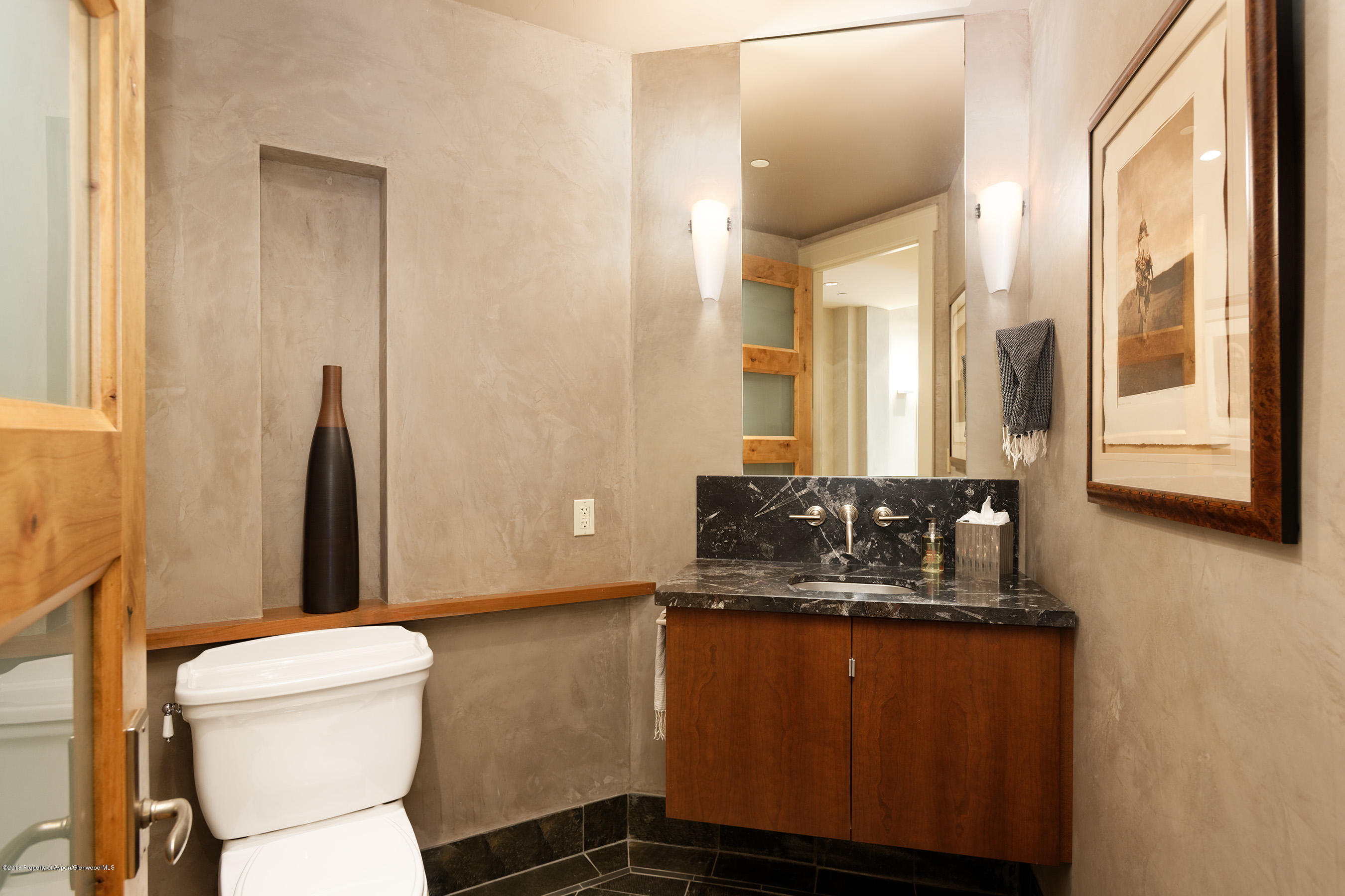 102 Founders Place, Unit 301 Aspen, CO 81611 - Photo 28 of 28 a bathroom with a granite countertop sink toilet and mirror