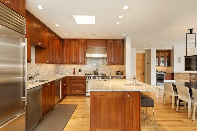 a kitchen with stainless steel appliances granite countertop a refrigerator sink and cabinets