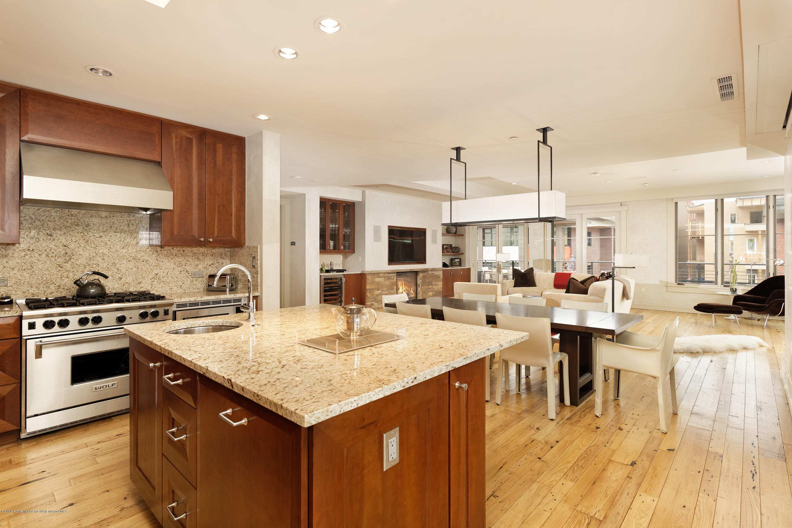 102 Founders Place, Unit 301 Aspen, CO 81611 - Photo 8 of 28 a open kitchen with stainless steel appliances granite countertop a table chairs and a stove