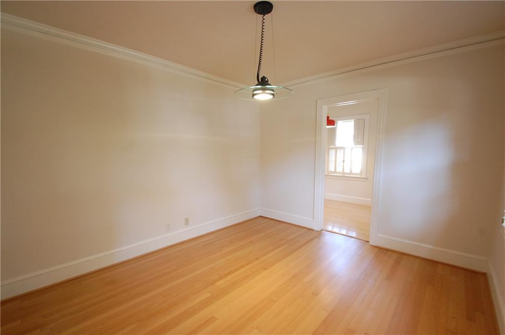 3347 College Street Atlanta, GA 30337 - Photo 12 of 39 an empty room with wooden floor ceiling fan and windows