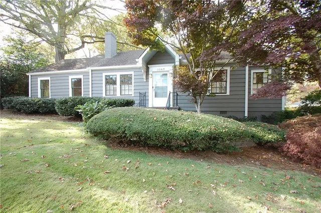 a front view of a house with a garden
