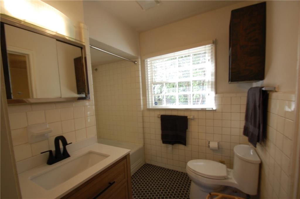 3347 College Street Atlanta, GA 30337 - Photo 21 of 39 a bathroom with a sink a toilet a window and shower