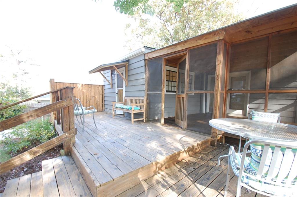3347 College Street Atlanta, GA 30337 - Photo 34 of 39 a view of a patio with a table and chairs floor to ceiling window with wooden floor