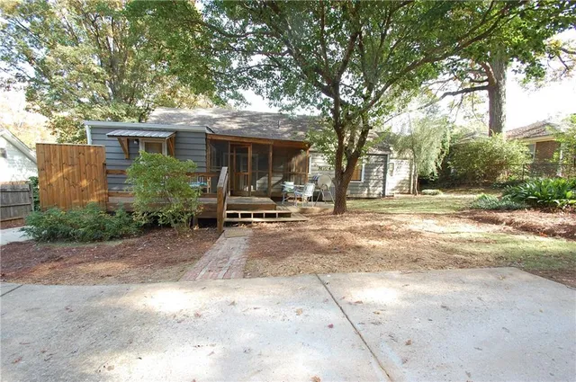 a view of a house with a tree in front