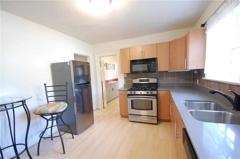 3347 College Street Atlanta, GA 30337 - Photo 7 of 39 a kitchen with granite countertop a refrigerator and a stove top oven
