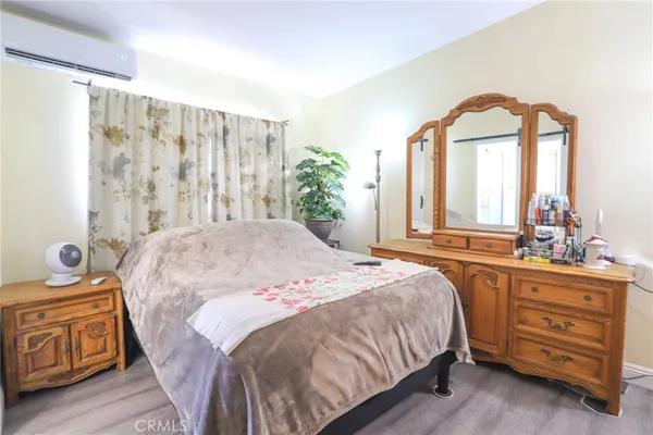 a bedroom with a bed and a dresser
