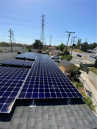 a living room with furniture large window and wooden floor