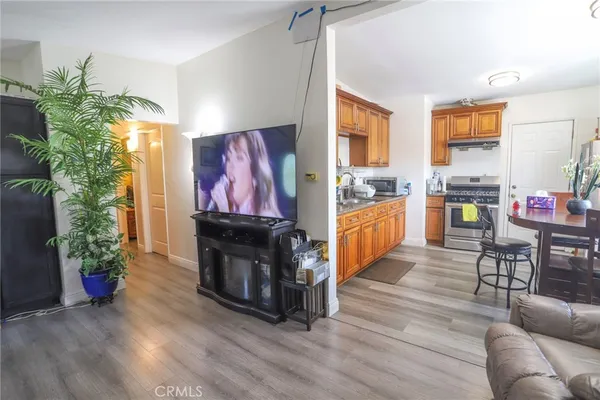 a living room with furniture large window and wooden floor
