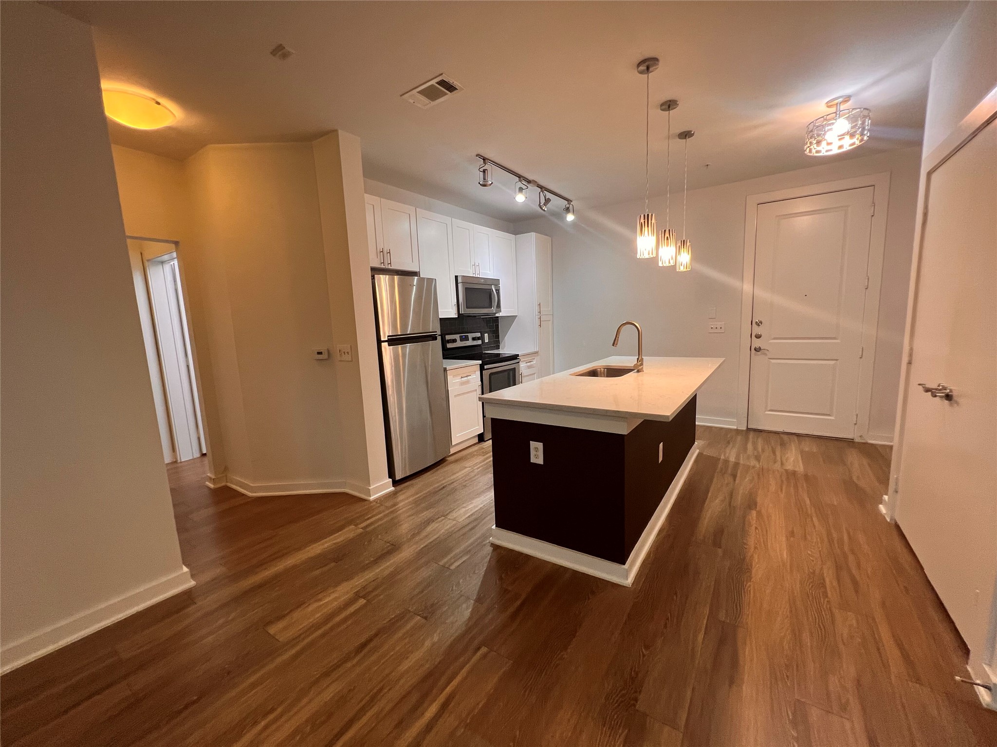 1900 Barton Springs Road, Unit 4041 Austin, TX 78704 - Photo 11 of 35 a kitchen with a refrigerator and a sink