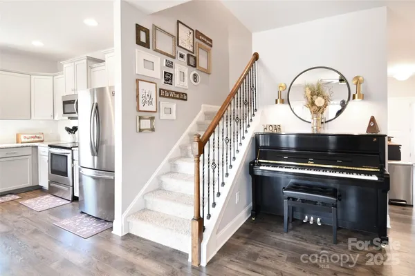 a view of an entryway with wooden floor and a rug