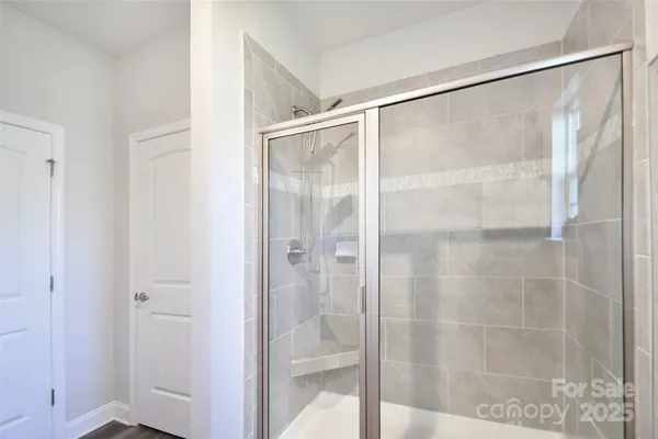 a bathroom with a glass shower door