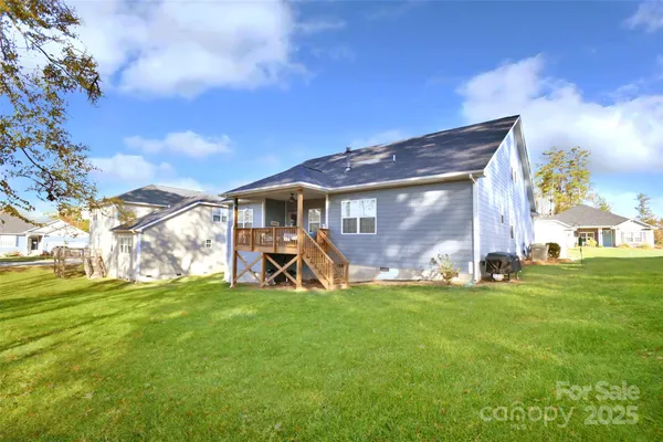 a view of a house with a yard and sitting area
