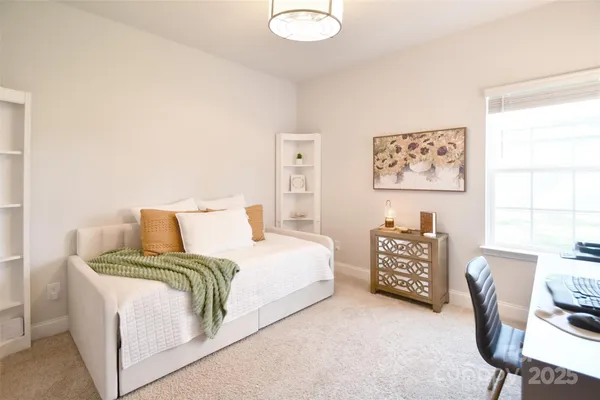 a bed room with a bed and a chair