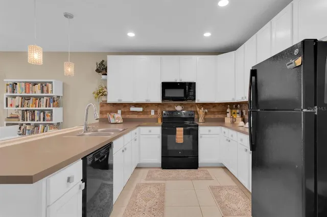 a kitchen with counter top space sink and center island