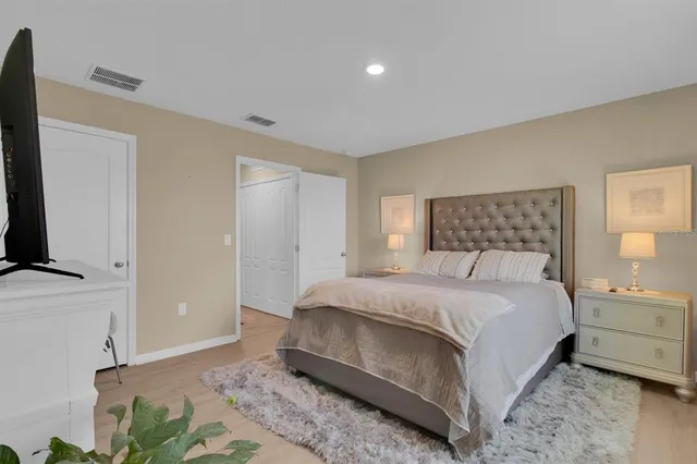 a bedroom with a bed and a flat screen tv