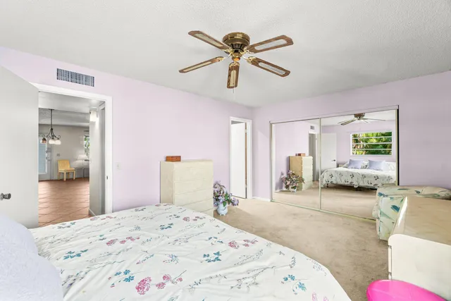 a bedroom with a bed and ceiling fan