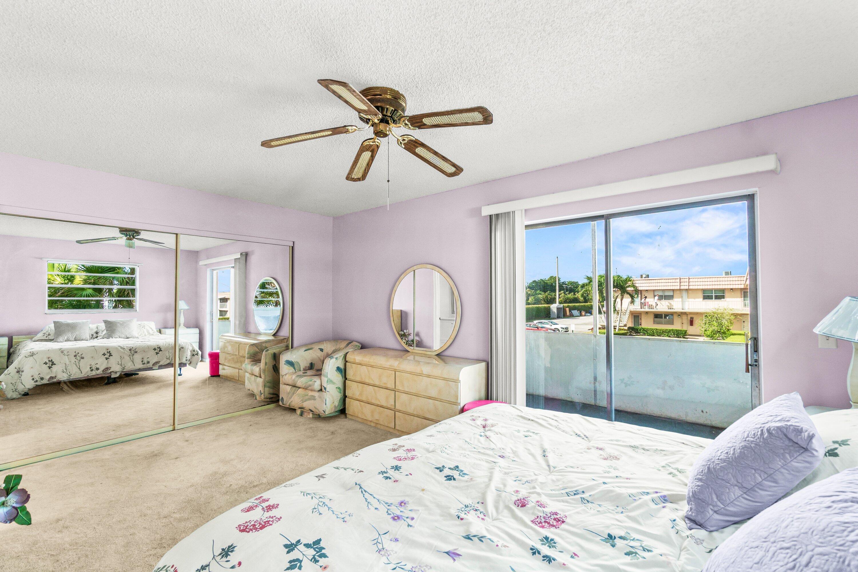 410 Saxony Way Delray Beach, FL 33446 - Photo 12 of 38 a bedroom with a bed and a window