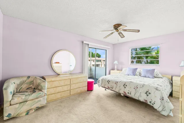 a bedroom with a bed window and dresser