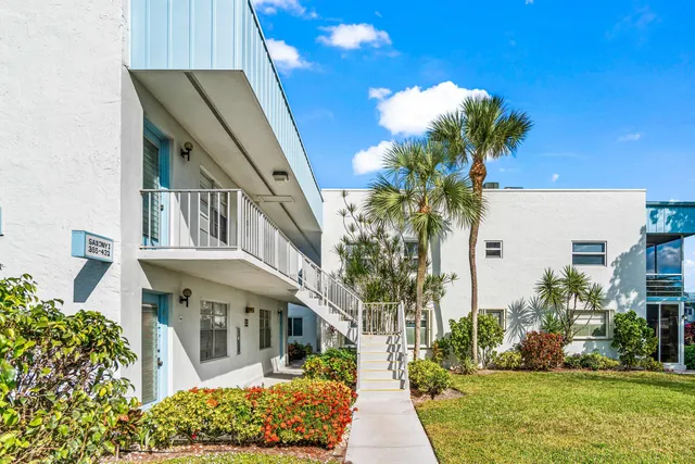 a front view of a house with a garden and patio