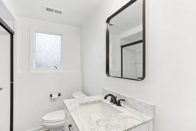 a livingroom with workspace and a window